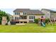 Expansive backyard with patio, grill, wooden deck, screen porch, play set, and lush green lawn at 2010 Brightflower Ln, York, SC 29745