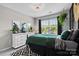 Inviting bedroom with a geometric rug, green bedding, large window and an accent wall at 2010 Brightflower Ln, York, SC 29745