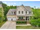 Charming two-story home with a manicured lawn, lovely landscaping, and a three-car garage at 2010 Brightflower Ln, York, SC 29745