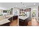 Spacious open kitchen features stainless appliances, dark cabinetry, and granite island at 2010 Brightflower Ln, York, SC 29745