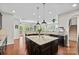 Bright kitchen with center island, dark cabinetry, and granite countertops at 2010 Brightflower Ln, York, SC 29745