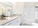 Bright bathroom featuring granite countertops and shower-tub combo at 212 Queens Ct, Gastonia, NC 28052