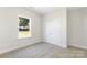 Cozy bedroom featuring soft carpet, a window and a closet with white doors at 212 Queens Ct, Gastonia, NC 28052