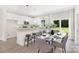 Contemporary dining area and kitchen featuring white cabinets, stainless steel appliances, and an open concept design at 212 Queens Ct, Gastonia, NC 28052