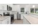 Stylish kitchen featuring granite countertops, stainless steel appliances, and sleek white cabinetry at 212 Queens Ct, Gastonia, NC 28052