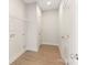 Clean laundry room with overhead shelving and wood-look vinyl flooring at 212 Queens Ct, Gastonia, NC 28052