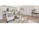 Open concept living space featuring modern furniture, hardwood floors, and natural light throughout at 212 Queens Ct, Gastonia, NC 28052