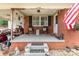 Inviting covered front porch with seating area, potted plants, and classic brick exterior at 2210 Joes Lake Rd, Shelby, NC 28152