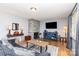 Comfortable living room features a stone fireplace, wood floors, and a cozy gray sofa at 2210 Joes Lake Rd, Shelby, NC 28152