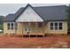 New home's covered back porch with wooden decking and support posts, offering a tranquil outdoor space at 2589 Polo Ln, Maiden, NC 28650