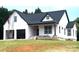 New construction home featuring white siding, dark roof, covered porch and an attached two car garage at 2589 Polo Ln, Maiden, NC 28650