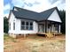 New construction home featuring white siding, dark roof, covered porch and wood deck at 2589 Polo Ln, Maiden, NC 28650