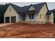 New construction exterior with a two-car garage and covered porch, showcasing modern design and quality craftsmanship at 2589 Polo Ln, Maiden, NC 28650