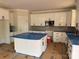 Spacious kitchen with white cabinets, stainless steel appliances, a central island, and elegant finishes at 2589 Polo Ln, Maiden, NC 28650