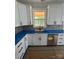Modern kitchen featuring white cabinets, stainless steel appliances, and a view of the backyard from the kitchen window at 2589 Polo Ln, Maiden, NC 28650