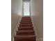 Stairway in the home, with protective coverings on each step, leads to an upper level of the house at 2589 Polo Ln, Maiden, NC 28650