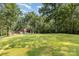 The property features a spacious lawn, mature trees, and a log-style home with a long driveway at 2709 Blythe Rd, Waxhaw, NC 28173