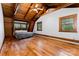 Spacious bedroom featuring wooden walls, natural lighting, and hardwood flooring at 2709 Blythe Rd, Waxhaw, NC 28173