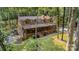 A charming log home boasts a spacious covered porch, nestled among mature trees and professionally landscaped grounds at 2709 Blythe Rd, Waxhaw, NC 28173