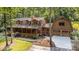 Spacious log home with a covered porch and an attached two-car garage at 2709 Blythe Rd, Waxhaw, NC 28173