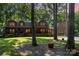Charming log home with a covered porch, lush lawn, and mature trees at 2709 Blythe Rd, Waxhaw, NC 28173