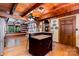 Kitchen with wood ceiling and island with seating, connecting to living and dining areas at 2709 Blythe Rd, Waxhaw, NC 28173