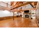 Open living room with stone fireplace, hardwood floors, and exposed beams at 2709 Blythe Rd, Waxhaw, NC 28173