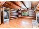 Living room featuring wood walls, wood ceiling, hardwood floors, and stone fireplace at 2709 Blythe Rd, Waxhaw, NC 28173