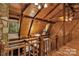 Open loft with wood ceilings and banister overlooking living area at 2709 Blythe Rd, Waxhaw, NC 28173