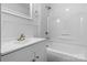 All-white bathroom featuring a modern vanity and a shower-tub combination at 2980 N Church St, Claremont, NC 28610
