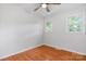 Bright bedroom features hardwood floors, a ceiling fan and two large windows at 2980 N Church St, Claremont, NC 28610
