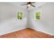 Bright bedroom features hardwood floors, a ceiling fan and two large windows at 2980 N Church St, Claremont, NC 28610