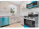 Updated kitchen featuring stainless steel appliances, white cabinets, and light countertops at 2980 N Church St, Claremont, NC 28610
