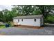 Rear exterior view with a small deck and gravel area at 2980 N Church St, Claremont, NC 28610