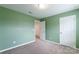 Carpeted bedroom with neutral carpet, green walls, and white trim at 3073 Langhorne Sw Ave, Concord, NC 28027