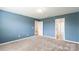 Large bedroom with cozy carpet, neutral walls, and multiple doorways, creating an open and inviting space at 3073 Langhorne Sw Ave, Concord, NC 28027