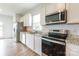 Modern kitchen featuring granite counters, stainless steel appliances, and ample cabinet space at 3073 Langhorne Sw Ave, Concord, NC 28027