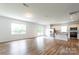 Spacious living area filled with natural light, featuring wood-look floors and a seamless flow to the kitchen at 3073 Langhorne Sw Ave, Concord, NC 28027