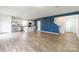 Bright, open-concept living area featuring wood-look flooring, modern lighting, and a bold accent wall at 3073 Langhorne Sw Ave, Concord, NC 28027