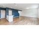 Open-concept living space with wood-look floors, recessed lighting, and a stylish accent wall at 3073 Langhorne Sw Ave, Concord, NC 28027
