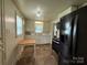 Cozy kitchen equipped with black appliances, ample white cabinetry, and a small wooden kitchen table at 317 Heilig Ave, Salisbury, NC 28144