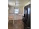 Well-lit kitchen featuring black appliances, abundant white cabinetry, and a charming wooden kitchen table at 317 Heilig Ave, Salisbury, NC 28144