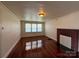 Open living room with hardwood floors and a brick fireplace at 317 Heilig Ave, Salisbury, NC 28144