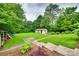 Expansive backyard with lush lawn and mature trees, featuring a charming storage shed at 3447 Filbert Hwy, Clover, SC 29710