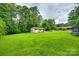 Large backyard featuring a storage shed and plenty of lush green grass at 3447 Filbert Hwy, Clover, SC 29710