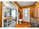 Charming entryway with wood paneling, hardwood floors, and a view into the adjacent kitchen and dining area at 3447 Filbert Hwy, Clover, SC 29710