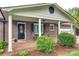Inviting covered front porch with brick flooring, rocking chairs, and classic white columns and trim at 3447 Filbert Hwy, Clover, SC 29710