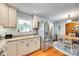 Well-lit kitchen with white cabinetry, stainless steel refrigerator, and a view into the cozy dining area at 3447 Filbert Hwy, Clover, SC 29710
