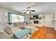Cozy living room with a white brick fireplace, hardwood floors, and a comfortable sectional sofa at 3447 Filbert Hwy, Clover, SC 29710