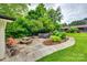 Cozy patio with a stone foundation, a fire pit, picnic table, outdoor furniture, and lush greenery offering a relaxing outdoor space at 3447 Filbert Hwy, Clover, SC 29710